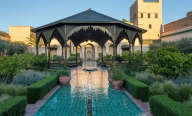 Exotic plants and traditional fountains inside Le Jardin Secret in Marrakech Medina